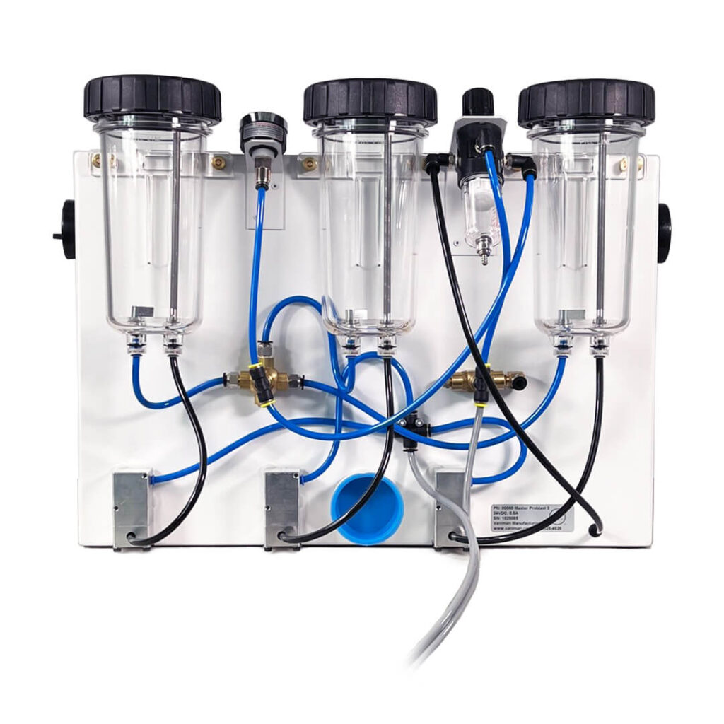 The back of a Vaniman Master Problast 3 (showing the three tanks, tube plumbing, and pinch valve cases.