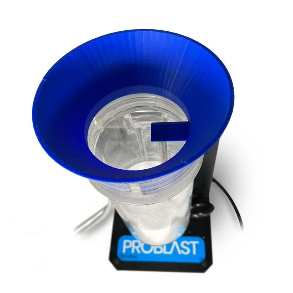 Top-down view of Vaniman tank funnel (PN 97998) properly seated, showing blocked manifold tube to prevent blasting media ingestion.