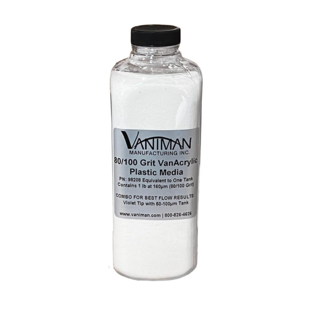 A clear glass bottle containing white plastic media for use in sandblasting and conformal coating removal.