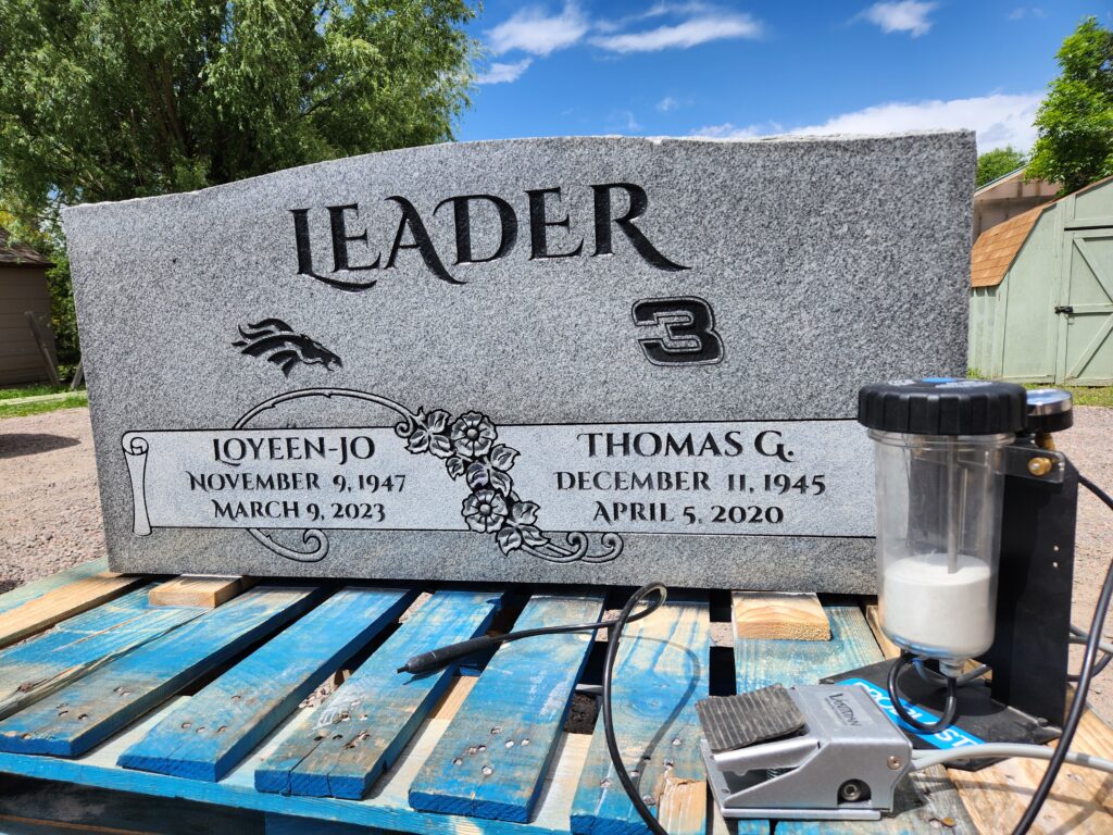 Memorial stone engraving next to a Vaniman Mobile Problast