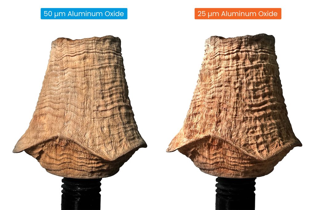 Comparison of 50 micron sandblasting to 25 micron sandblasting on a wood pipe.